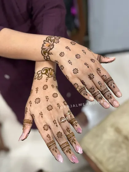 A minimal and trendy design for the bride's sister, with scattered floral motifs and a simple wrist cuff.