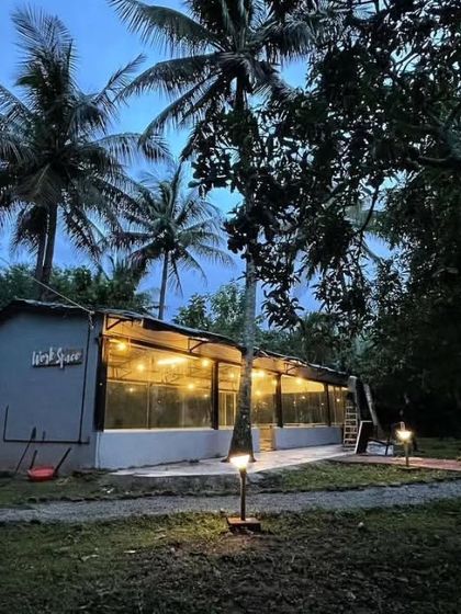 The communal area of a hostel in Chikmagalur, beautifully lit up at dusk. It's a wonderful place to meet fellow travelers, share stories, and relax under the stars after a day of hiking and exploring the coffee plantations.