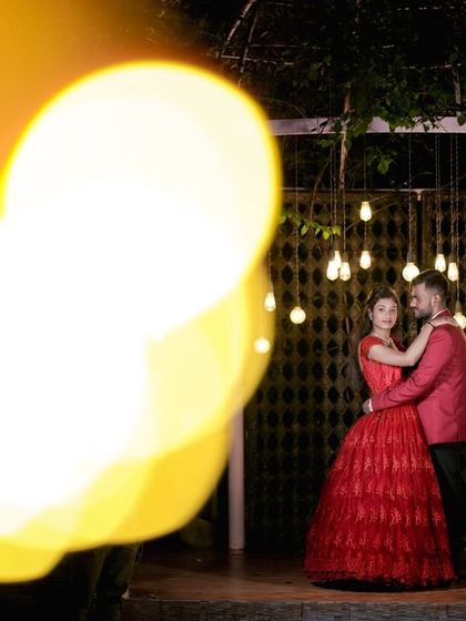 A creative shot using bokeh from the foreground lights to frame the couple against our rustic gate backdrop.