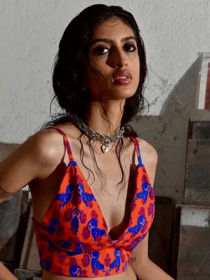 An edgy, wet-look hairstyle paired with glossy lips and smokey eyes for a gritty, street-style photoshoot.