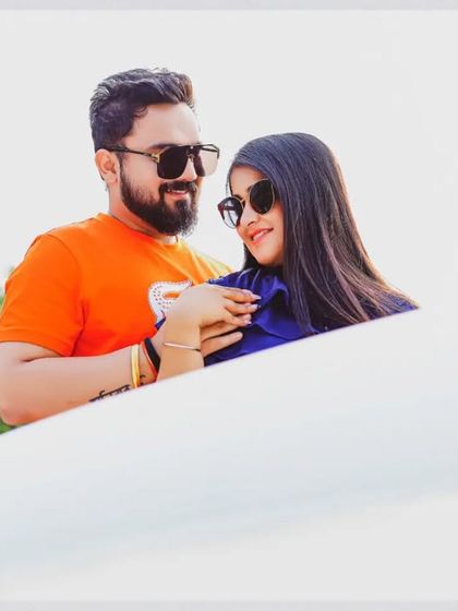 A bright and happy pre-wedding photo with a clean, high-key look. The focus is entirely on the couple's joyful interaction, making for a fresh and modern portrait.