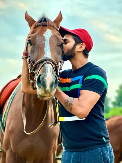 A rider gives his horse an affectionate kiss on the head. We see these moments of pure love for our animals every day at the center.