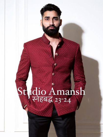 The front view of our crimson bandhgala, a piece that embodies confidence. The rich color and detailed fabric texture make it a perfect selection for a groom's reception outfit or a formal gala.