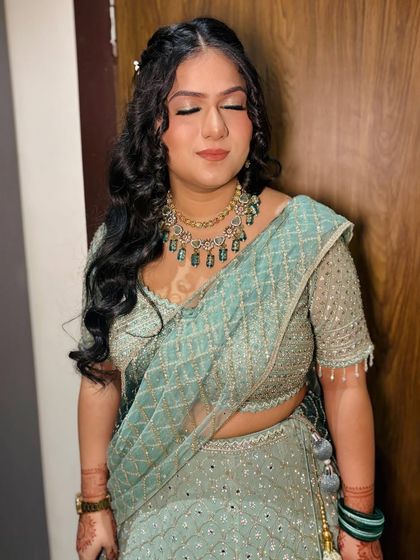 A close-up with eyes closed, showing the soft, shimmery eyeshadow.