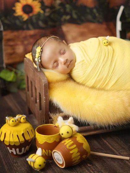 A full view of the honey bee setup, with the newborn sleeping soundly on a miniature bed.