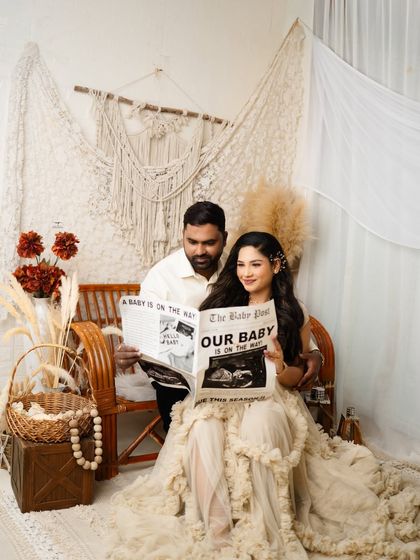 The best way to announce your news. Using our custom "The Baby Post" newspaper prop, this couple shares their excitement in a fun and creative way during their boho session.