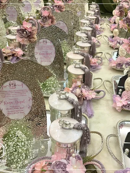 A view of a large, coordinated order for a baby girl's announcement. Each hamper is meticulously arranged with personalized photo frames, silver jars, and soft lavender floral details, showcasing my ability to handle grand celebrations with consistent elegance.