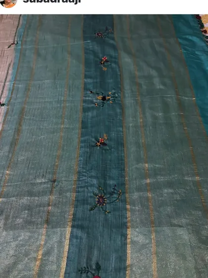 A full look at a custom-embroidered saree for a client. The scattered floral motifs are placed thoughtfully, drawing the eye along the length of the fabric.