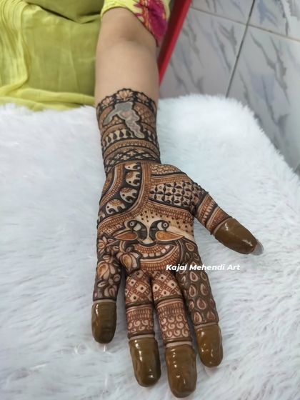 A detailed look at a single-hand design done by my team. The precision in the peacock and check patterns shows the skill and dedication we bring to every client.