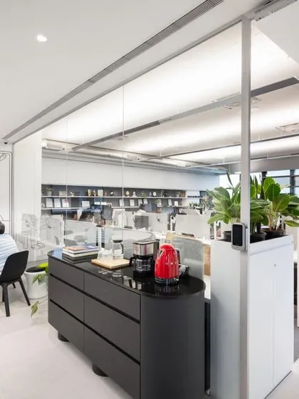 A view of our own office, showing the blend of collaborative tables and open workstations. Planters are used extensively to divide the space and create a healthy working environment.