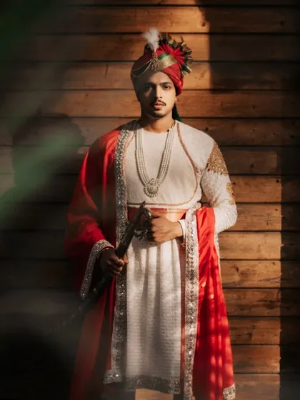 A regal portrait of a groom in traditional Maratha attire. We pay close attention to groom portraits, using light and shadow to highlight the dignity and anticipation of the wedding day.