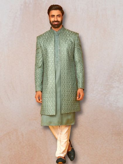 A full view of the sage green sherwani with intricate embroidery and mirror work. It's a sophisticated choice for any festive occasion.