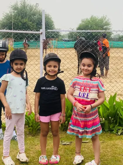 A group of young girls ready for their riding lesson. It's a great way for friends to learn a new skill and have fun together.