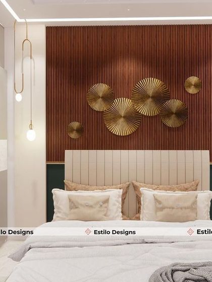 This bedroom design uses a rich wood-paneled accent wall with circular brass metal art to create a warm and inviting focal point. The pendant lights add a touch of modern elegance, complementing the clean lines of the wardrobe and headboard.