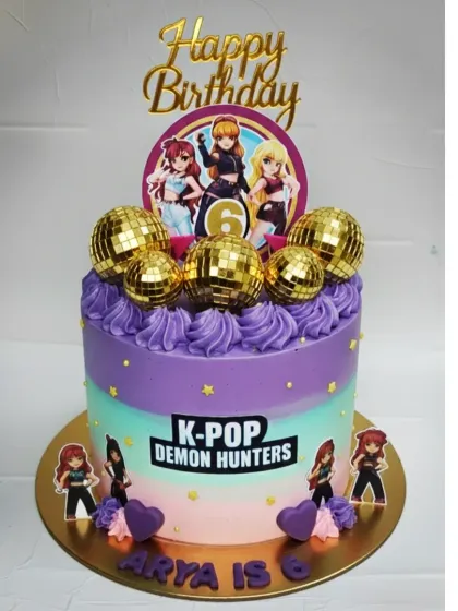 Another take on the K-Pop Demon Hunters theme. This vibrant choco-vanilla cake is decorated with golden disco balls and a colorful pastel frosting.