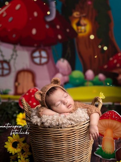 A tiny bear cub napping in a magical mushroom forest. Our fantasy backdrops and detailed props create a storybook scene for your newborn's first photos.