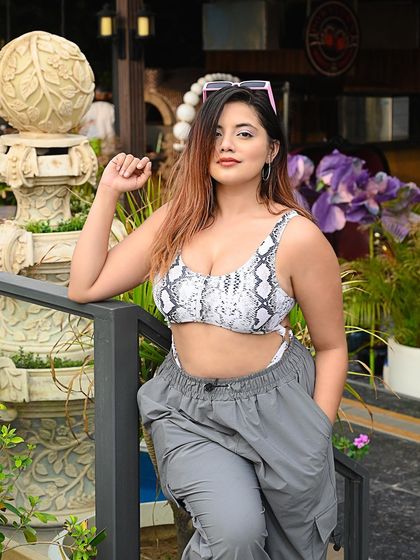 A relaxed pose against a beautiful architectural backdrop, blending fashion with travel.