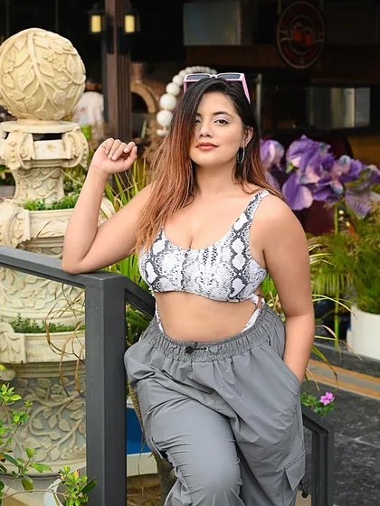 A relaxed pose against a beautiful architectural backdrop, blending fashion with travel.