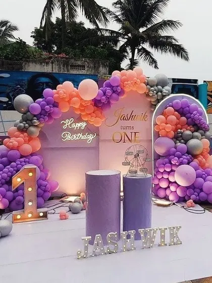 A serene and stylish lavender-themed first birthday for Jashwik. The purple and peach balloon arrangement creates a beautiful and unique color combination.