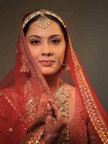 A close-up shot capturing the bride's soft and gentle expression. The makeup is minimal yet elegant, with perfectly defined eyes and a natural finish.