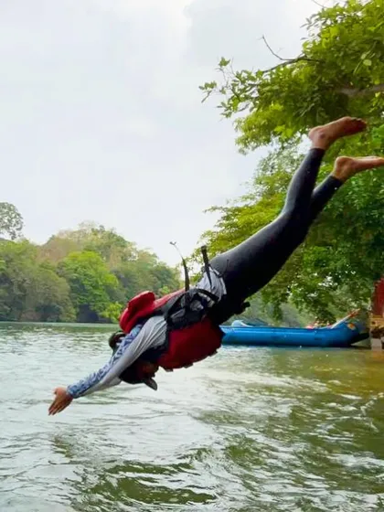 A participant takes a joyful leap into the river during our white-water adventure course in Dandeli. We create a safe environment for campers to push their boundaries and have fun.