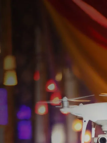 A detailed shot of my drone hovering during an indoor event. The warm, colorful lights in the background highlight the vibrant atmosphere I aim to capture, showing how aerial photography can work beautifully even inside.