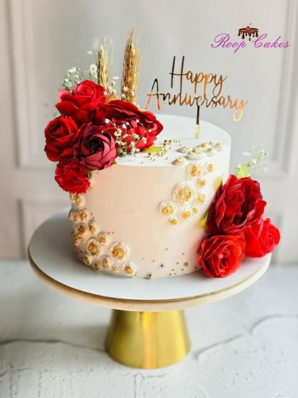 Sweet moments, lasting love. This stunning anniversary cake with bold red roses and golden stencil work is perfect for celebrating another year together.