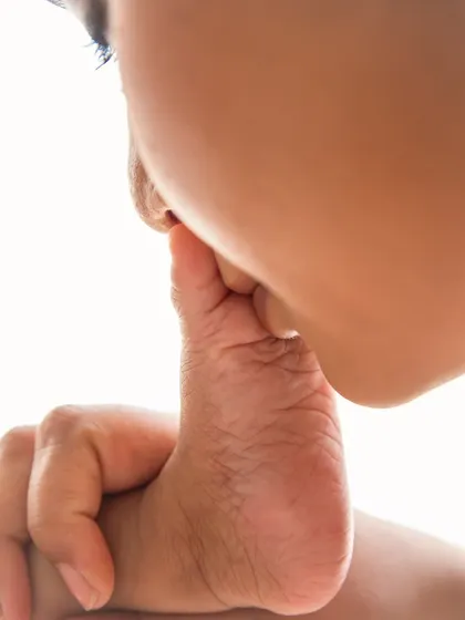 A mother's tender kiss on her baby's tiny foot. It's a classic, heartwarming pose that symbolizes the immense love and adoration a parent feels.