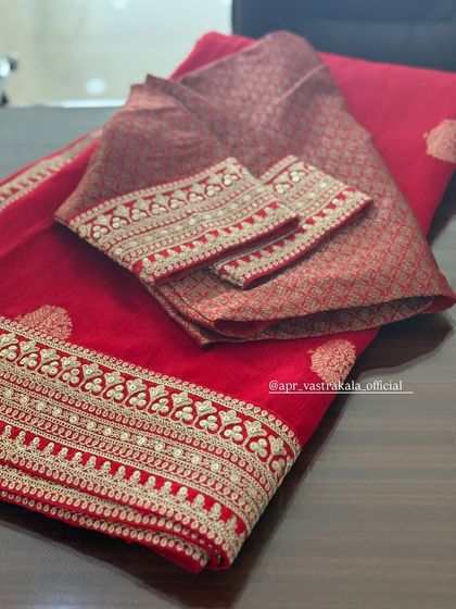 A red brocade blouse with a simple but elegant embroidered border.