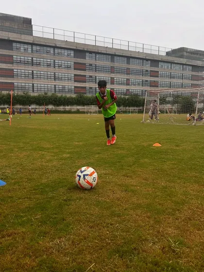 A young player preparing to strike the ball during a training session. Passion is the fuel for every dream.