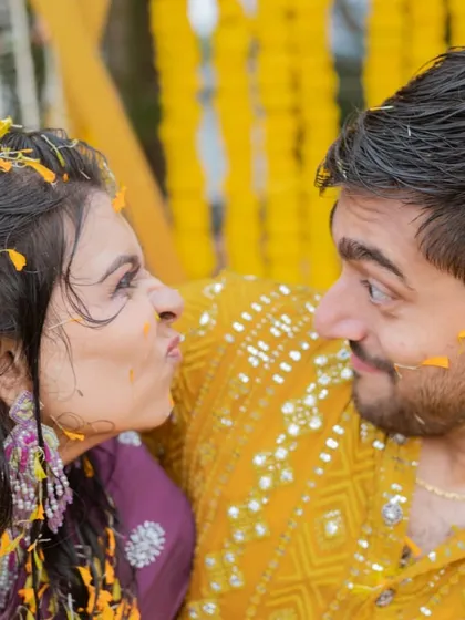 A fun and playful couple shot from the Haldi ceremony. Drenched in haldi, love, and laughter, this is what pre-wedding celebrations are all about.