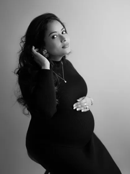 I love capturing these in-between moments. A candid black and white shot where she adjusts her hair, looking up with a soft, beautiful expression.