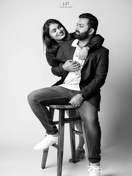 A joyful black and white candid from a studio session, capturing a genuine moment of laughter.