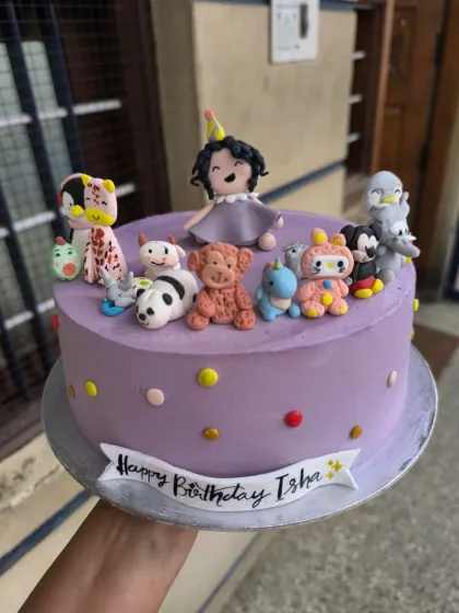 This super cute cake was for my niece's first birthday. It features her surrounded by all her favorite toys, handcrafted from fondant, including a panda, giraffe, and teddy bear.