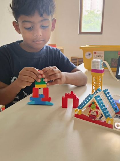 From simple structures to complex machines, our summer camp curriculum is designed to grow with your child. This young student is carefully constructing a model, learning about design and stability with LEGO bricks.