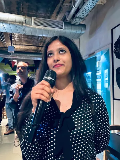 Lost in the music. A guest takes her turn at the mic, showcasing the focused yet fun atmosphere of our Friday night karaoke sessions.