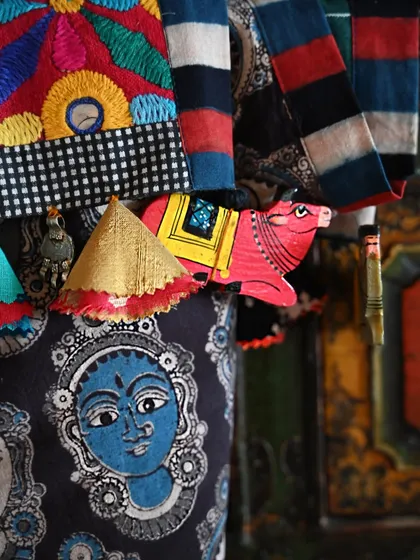 A detail shot of a custom patchwork runner, showing the quirky, hand-painted cow trims and a mix of vintage Sindhi embroidery and Kalamkari fabric.