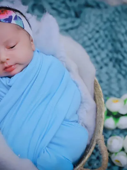 A close-up portrait of a peacefully sleeping newborn girl. Her delicate features are the star of the show in this simple, beautiful shot.