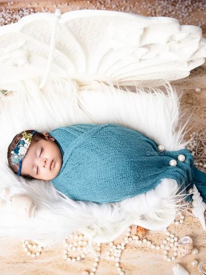 A beautiful mermaid-inspired photo with the baby nestled on a bed of sand and shells. Our ocean themes are perfect for creating a dreamy, beach-like atmosphere.