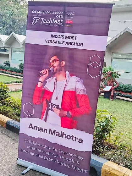 A closer look at the banner for Techfest, highlighting my role as 'India's Most Versatile Anchor' for events like Technoholix and the Drone Racing League.