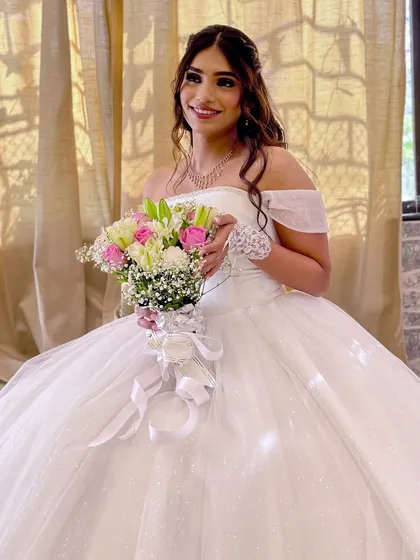 A Christian bride looking like a princess in her ball gown. The soft glam makeup and dreamy curls complete the fairytale look.