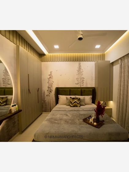 A full view of a master bedroom, showing the wardrobe, dressing table, and bed. The cohesive design and color palette create a harmonious and relaxing space.