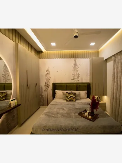 A full view of a master bedroom, showing the wardrobe, dressing table, and bed. The cohesive design and color palette create a harmonious and relaxing space.