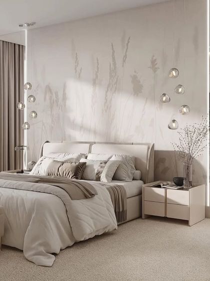 A serene bedroom with a beautiful, subtle wallpaper and delicate drop-down lights. The overall effect is calm, airy, and incredibly chic.