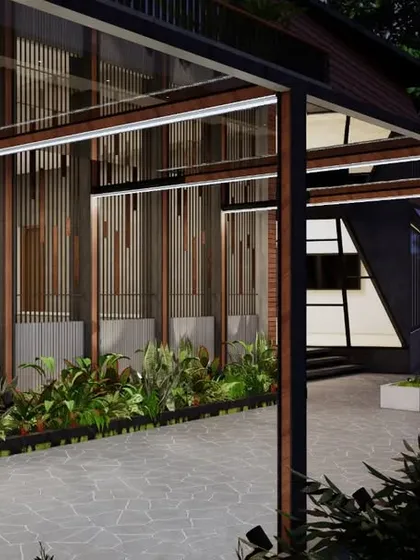 For this luxury home in Mangalore, we designed a modern pergola structure that creates a shaded walkway. This element adds architectural interest while providing a gentle transition from the exterior to the interior, complemented by integrated planters.