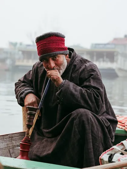A portrait of a Kashmiri man enjoying his hookah on a boat. Capturing the faces and traditions of a place is just as important as capturing its landscapes.