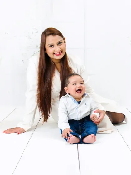 The pure, uncontainable laughter of a baby boy sitting with his mother. It's these genuine expressions that make for the most precious memories.