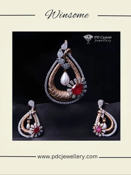 A winsome and unique pendant set in 14kt rose gold. The design features a teardrop shape with a ruby and pearl accent, blending classic and contemporary elements.