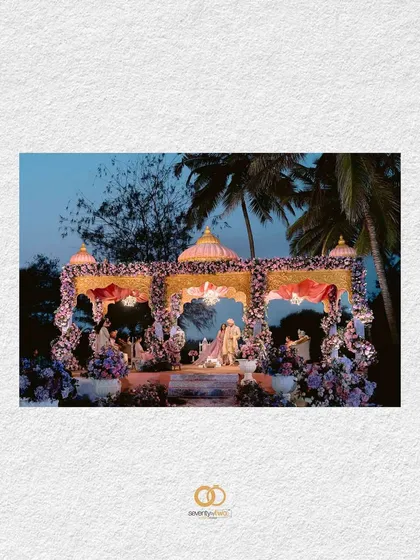 A beautifully framed shot of the wedding mandap in Goa, set against the evening sky, hinting at the grandeur and romance of the ceremony to come.