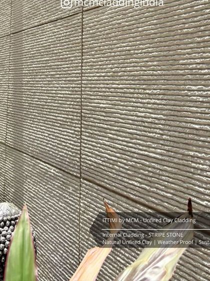 A close-up of the 'Stripe Stone' Ittimi clay cladding. This sustainable, unfired clay material is weatherproof and perfect for creating serene interior spaces.